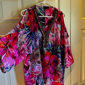 Multi colored top with split sides and open shoulders. Beading at the v neck